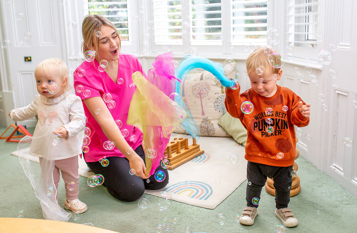 Children playing with bubbles in nursery